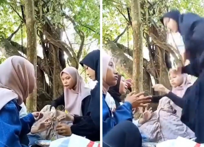 شاهد .. ثعبان ضخم يداهم أسرة إندونيسية أثناء تناولها الطعام في الغابة ويبعثر جمعتهم!